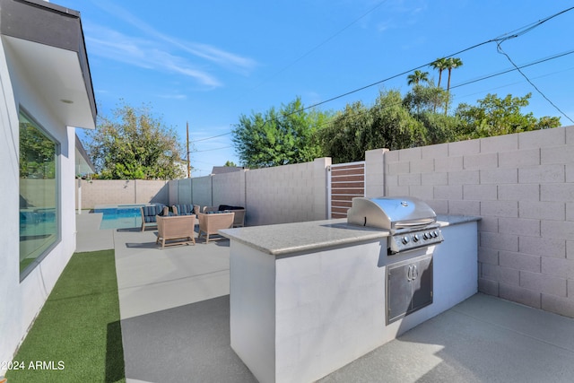 view of patio / terrace featuring a fenced in pool, area for grilling, and grilling area