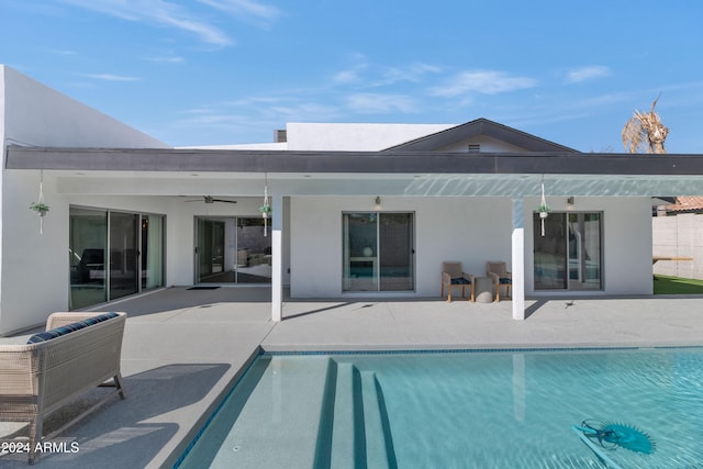 view of swimming pool featuring ceiling fan and a patio