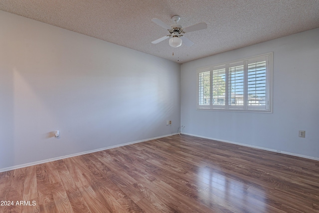 spare room featuring ceiling fan, hardwood / wood-style floors, and a textured ceiling