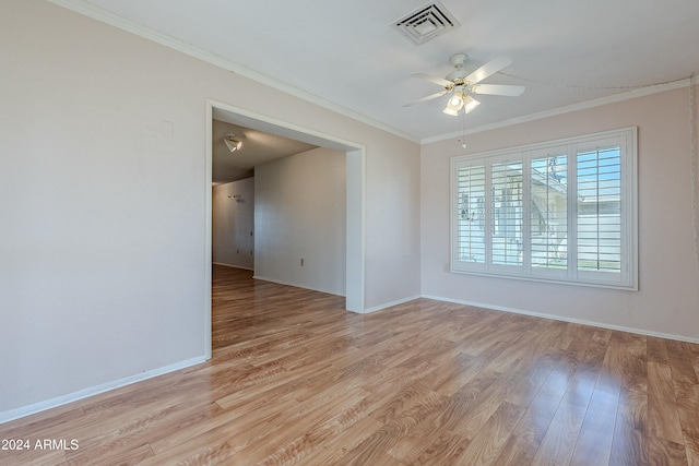 spare room with crown molding, ceiling fan, and light wood-type flooring