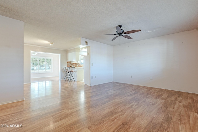 unfurnished room with ceiling fan, a textured ceiling, and light hardwood / wood-style floors