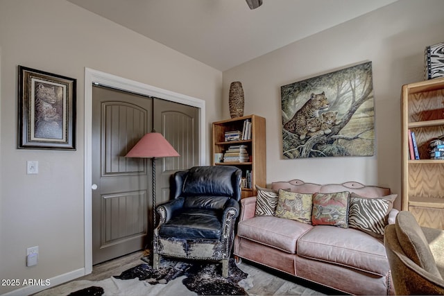 living room featuring baseboards and wood finished floors