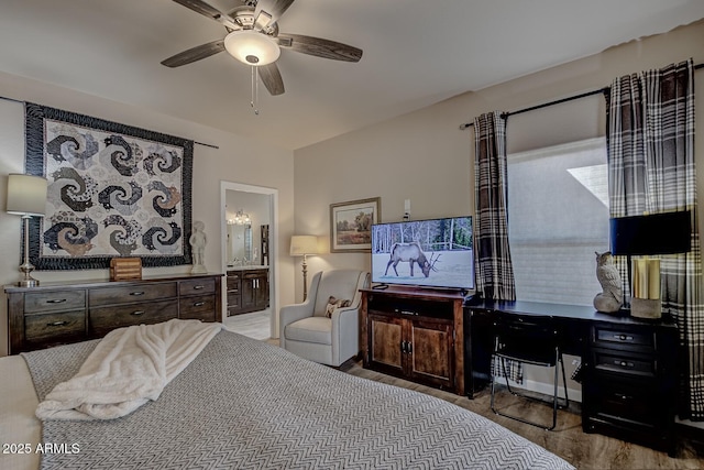 bedroom featuring a ceiling fan and ensuite bathroom