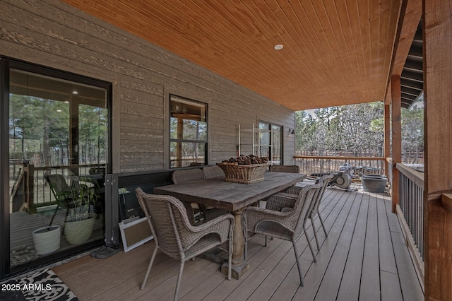 wooden deck featuring outdoor dining area