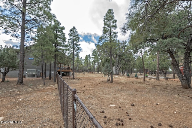 view of yard featuring fence and a wooden deck