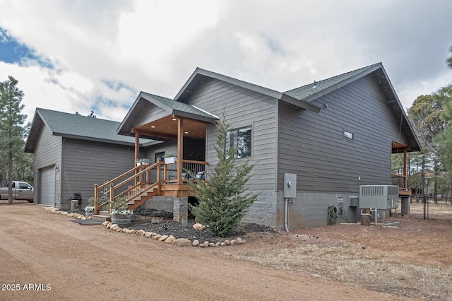 view of front of house with a garage and fence