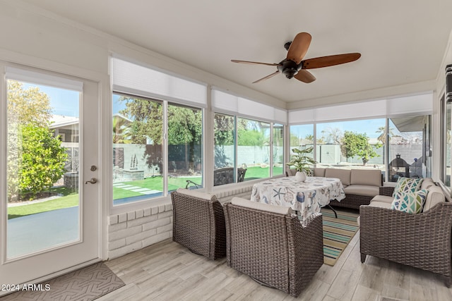 sunroom / solarium featuring ceiling fan