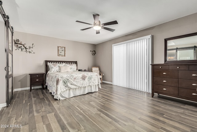 bedroom with ceiling fan and dark hardwood / wood-style floors