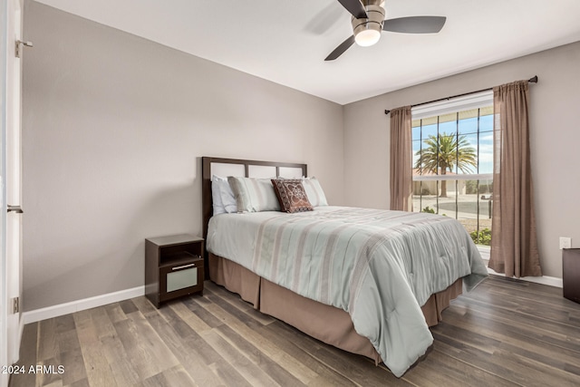 bedroom with ceiling fan and dark hardwood / wood-style flooring