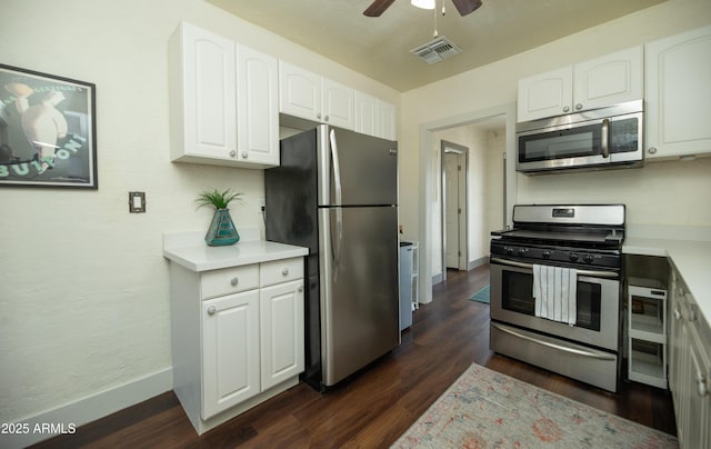 kitchen featuring white cabinetry, ceiling fan, stainless steel appliances, and dark wood-type flooring