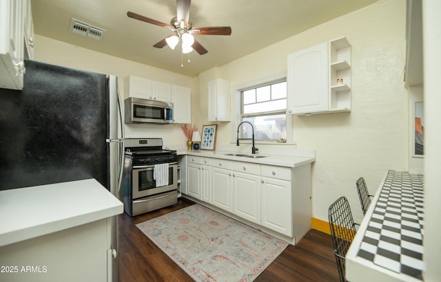 kitchen with white cabinetry, stainless steel appliances, dark wood-type flooring, and sink