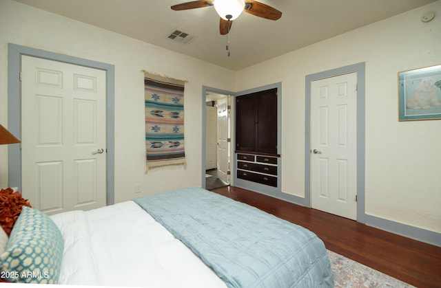 bedroom with dark wood-type flooring and ceiling fan