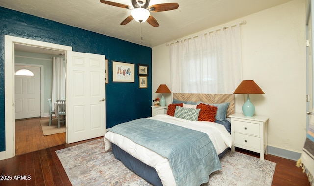 bedroom featuring dark wood-type flooring and ceiling fan