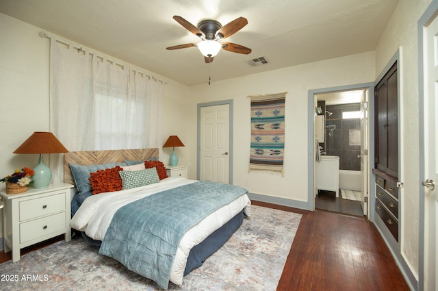 bedroom with ceiling fan, connected bathroom, and dark hardwood / wood-style flooring