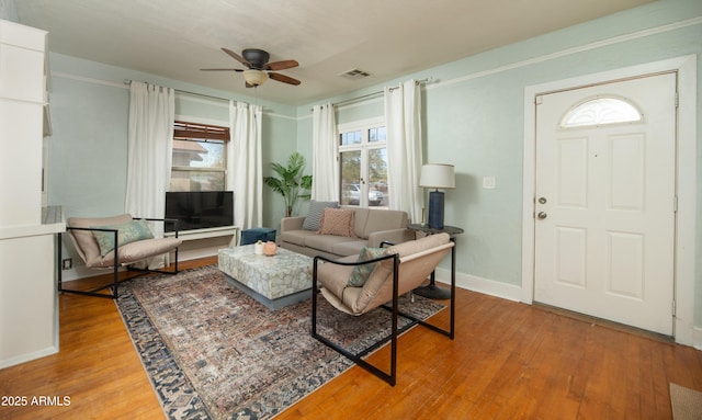 living room featuring hardwood / wood-style floors and ceiling fan