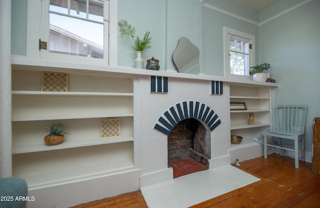 details with hardwood / wood-style flooring and a brick fireplace