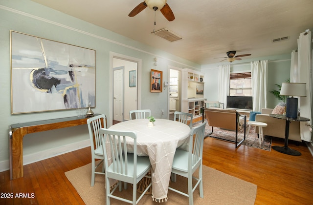 dining room featuring wood-type flooring and ceiling fan