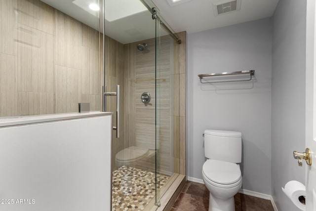 bathroom with walk in shower, tile patterned floors, and toilet