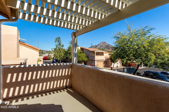 balcony featuring a mountain view and a pergola