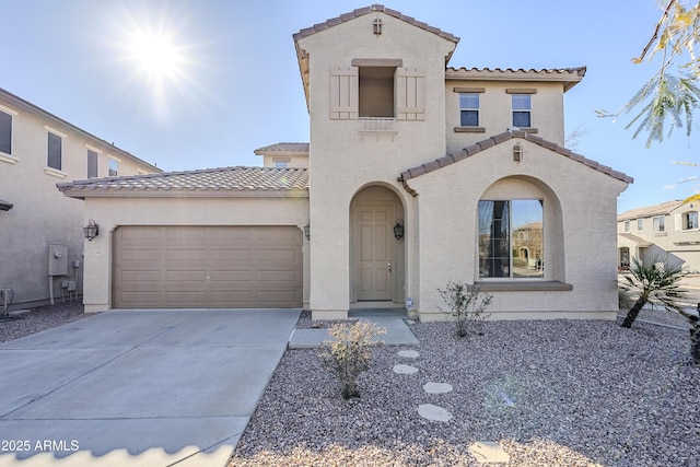 mediterranean / spanish-style home with a garage