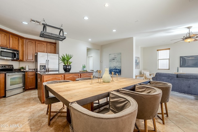 kitchen with stainless steel appliances, ceiling fan, and light tile patterned flooring