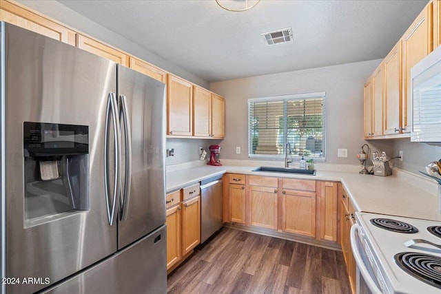 kitchen featuring light brown cabinetry, stainless steel appliances, sink, and dark hardwood / wood-style flooring