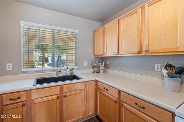 kitchen featuring light brown cabinetry and sink