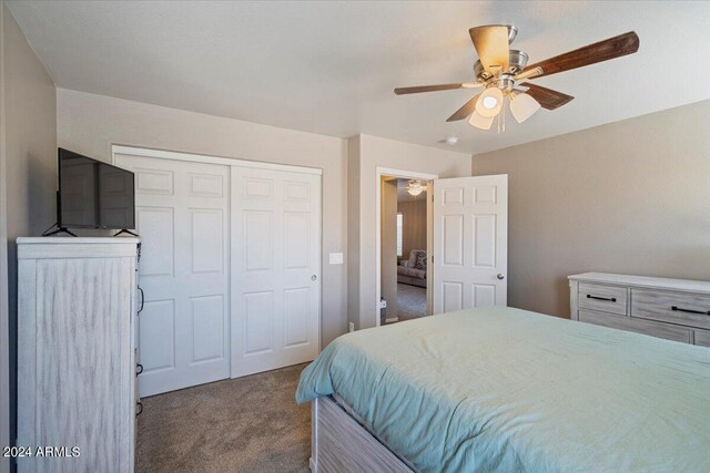 carpeted bedroom featuring a closet and ceiling fan