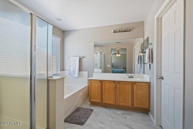 bathroom featuring independent shower and bath, vanity, and ceiling fan