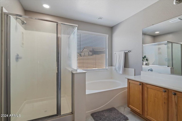 bathroom with tile patterned floors, independent shower and bath, and vanity