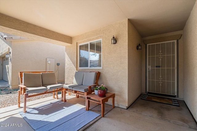 doorway to property featuring a patio and outdoor lounge area