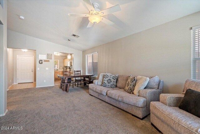 dining room with vaulted ceiling and dark colored carpet