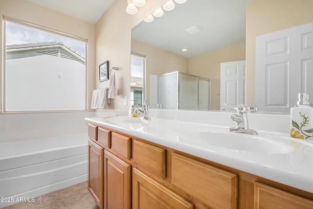 bathroom with independent shower and bath, vanity, and tile patterned floors