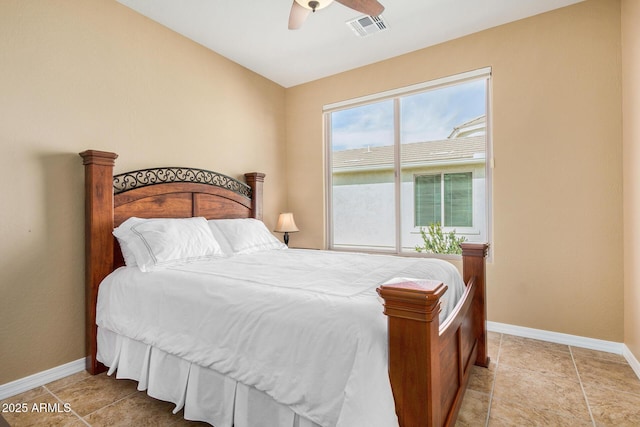 bedroom with ceiling fan and light tile patterned floors