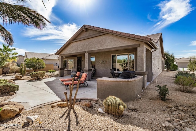 rear view of property featuring a patio area