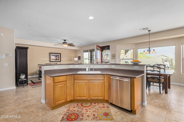 kitchen featuring hanging light fixtures, sink, a kitchen island with sink, and stainless steel dishwasher