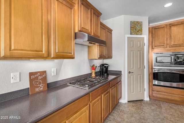 kitchen with stainless steel appliances and light tile patterned floors