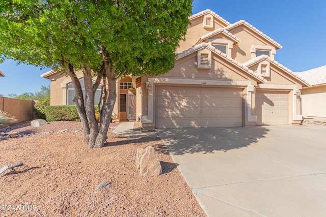 4356 E Rancho Tierra Dr, Cave Creek, AZ 85331 - view of front of house with an attached garage, driveway, stucco siding, and a tile roof