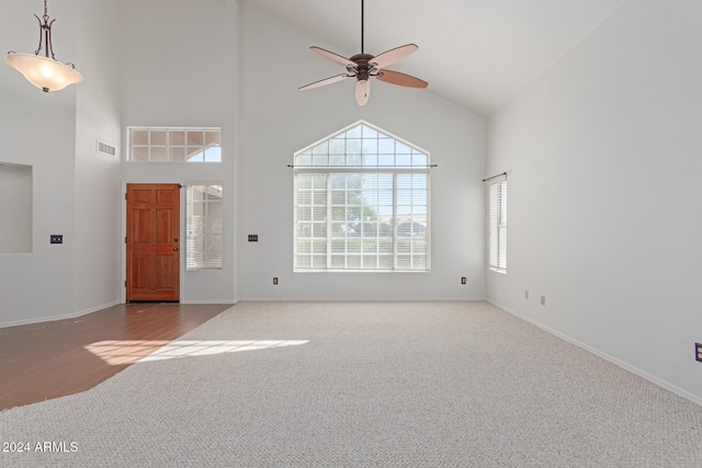 foyer entrance featuring hardwood / wood-style flooring, high vaulted ceiling, and ceiling fan