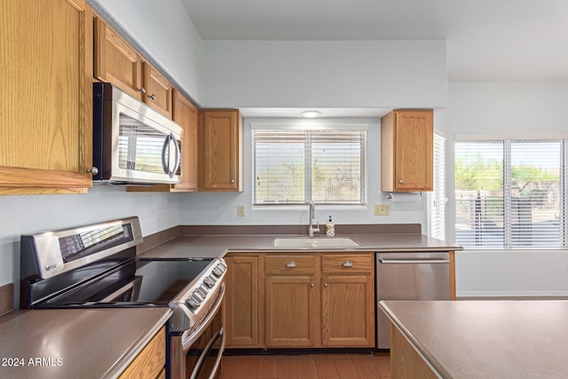 kitchen featuring sink, appliances with stainless steel finishes, and a healthy amount of sunlight