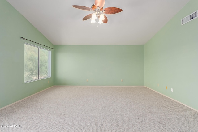 empty room with lofted ceiling, carpet, and ceiling fan