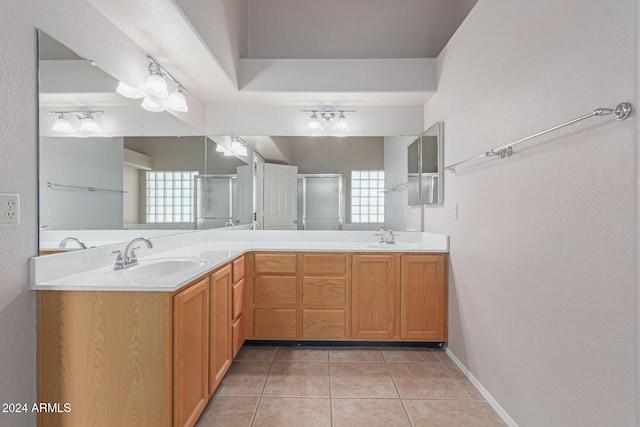 bathroom with vanity, walk in shower, and tile patterned flooring