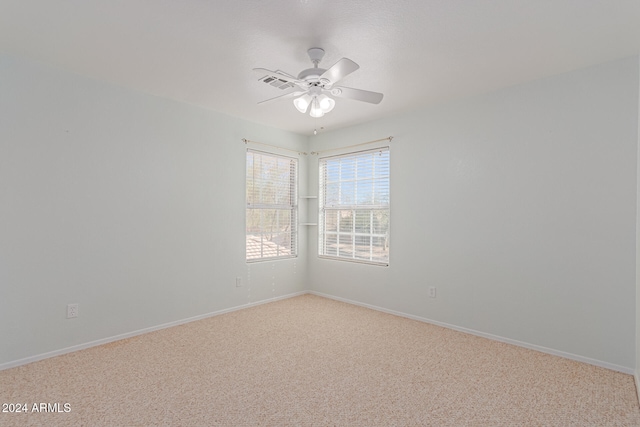 carpeted empty room featuring ceiling fan