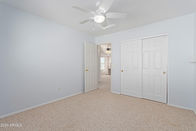 unfurnished bedroom with a closet, ceiling fan, and carpet flooring