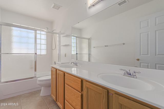 full bathroom with vanity, toilet, combined bath / shower with glass door, and tile patterned flooring