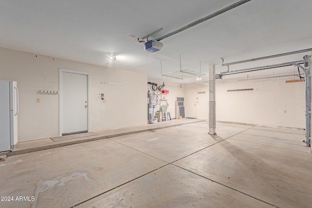 4356 E Rancho Tierra Dr, Cave Creek, AZ 85331 - garage featuring a garage door opener, freestanding refrigerator, and water heater