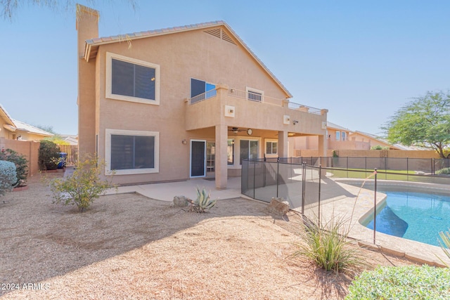 4356 E Rancho Tierra Dr, Cave Creek, AZ 85331 - rear view of house featuring stucco siding, a fenced backyard, a chimney, a patio area, and a ceiling fan