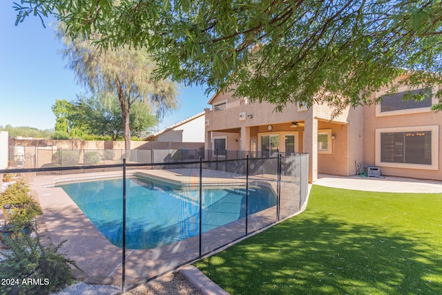 view of swimming pool featuring a patio area and a lawn