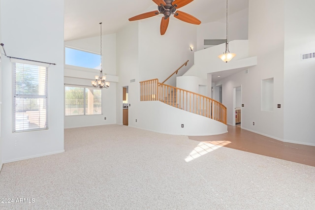4356 E Rancho Tierra Dr, Cave Creek, AZ 85331 - unfurnished living room with carpet floors, high vaulted ceiling, a chandelier, stairs, and a ceiling fan