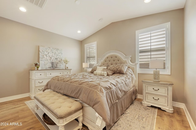 bedroom with light hardwood / wood-style flooring and lofted ceiling